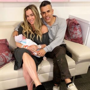 Photo of Teddi, her husband and their third baby daughter
