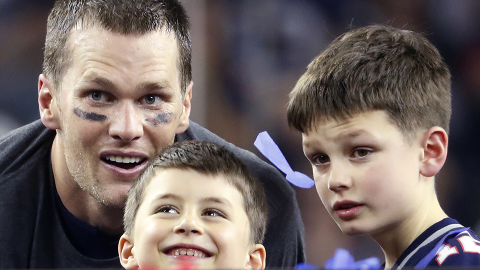 New England Patriots quarterback Tom Brady (12) shares a moment with his sons Benjamin and Jack (John) after an NFL Super Bowl 51 football game against the Atlanta Falcons on Sunday, Feb. 5, 2017, in Houston, TX. The Patriots defeated the Falcons 34-28 in overtime. (Kevin Terrell via AP)